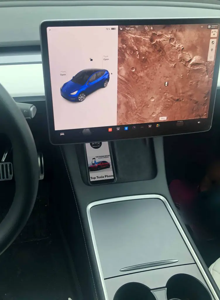 Tesla phone charging pad from the view of the driver. The phone is blocked by the touchscreen. Why we are recommending the Best Tesla iPhone Mounts