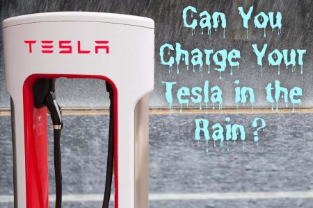 Tesla supercharger in the rain. Title read Can you Charge a Tesla in the Rain?