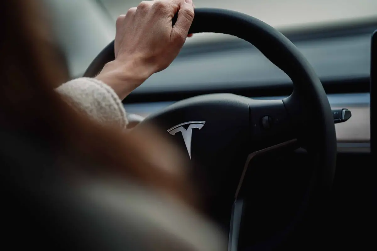 woman driving a tesla - Myths About Electric Vehicles