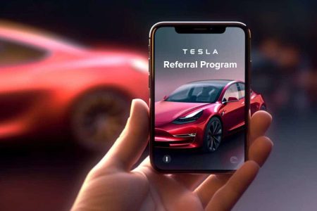 someone holding a phone, the screen says Tesla Referral Program