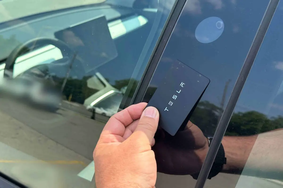 taping the key card on the middle post to Lock a Tesla