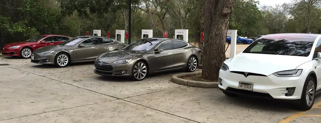 Four Tesla at a supercharger.  Tesla Charging Speeds can vary.